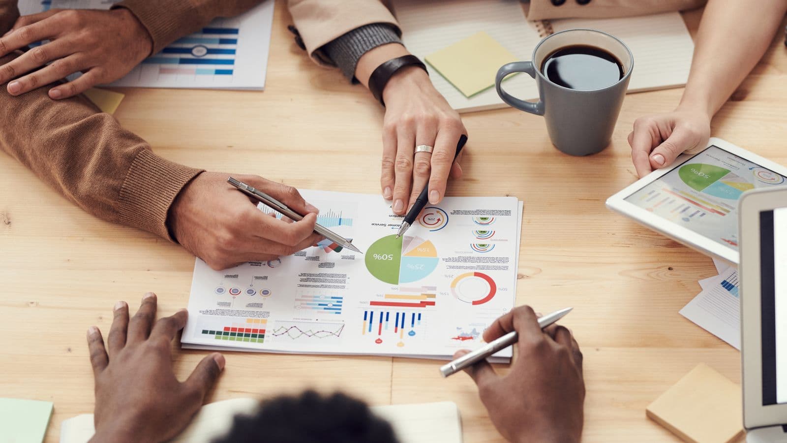 Advisers and an owner going through business reports