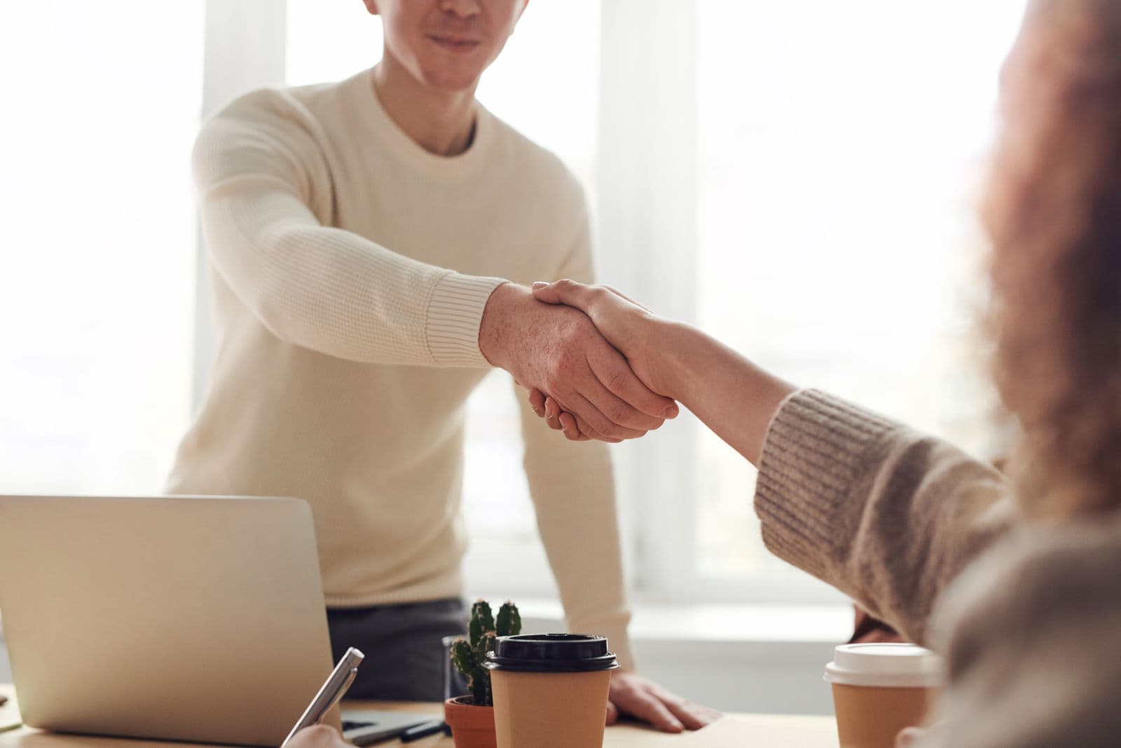 An adviser shaking hands with a business owner